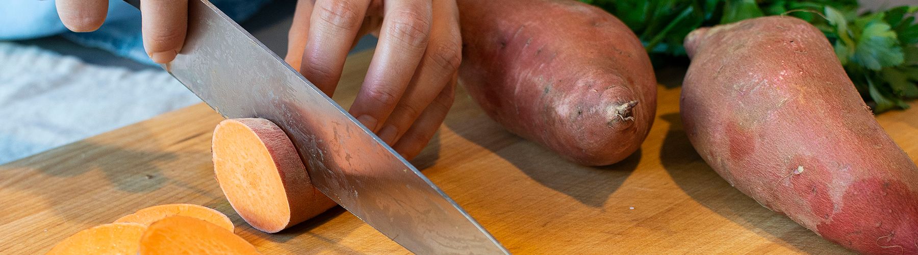 Hands Cutting Sweet Potatoes